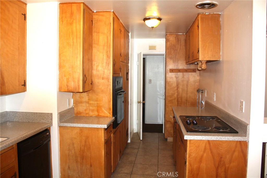 6458 Rhonda Road Riverside, CA 92504 - Photo 12 of 47 a kitchen with a refrigerator a stove and a sink