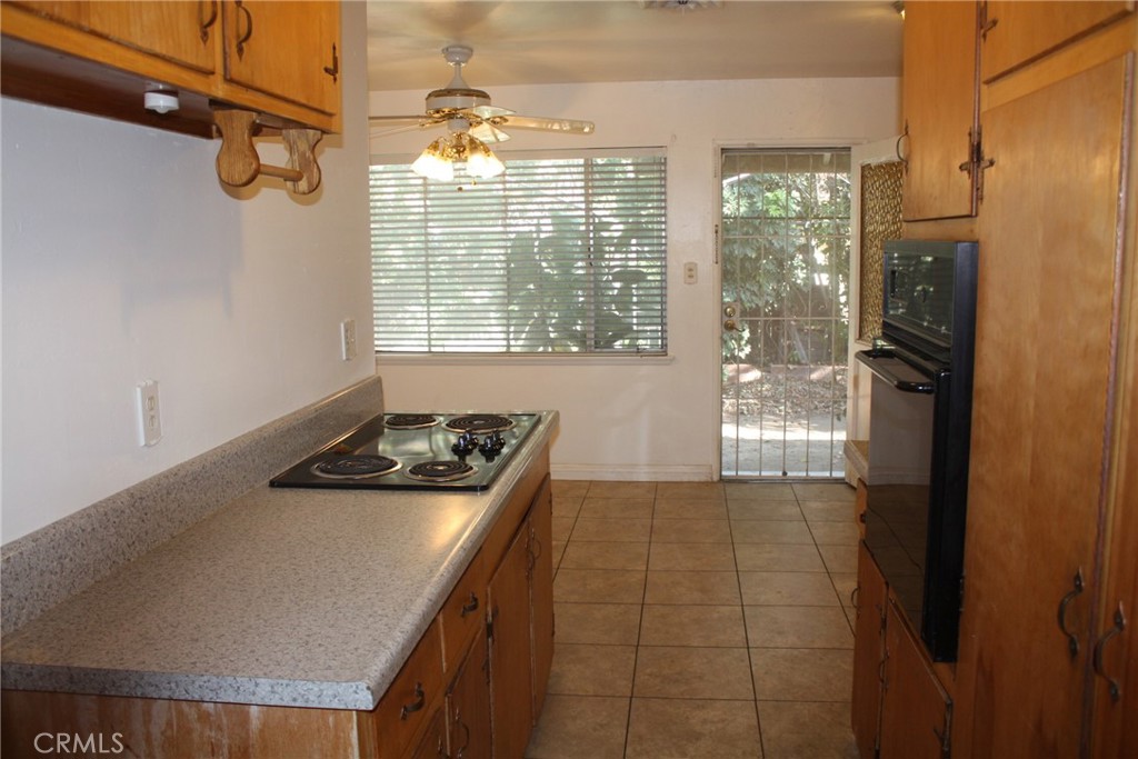 6458 Rhonda Road Riverside, CA 92504 - Photo 14 of 47 a kitchen with a refrigerator a stove and a window