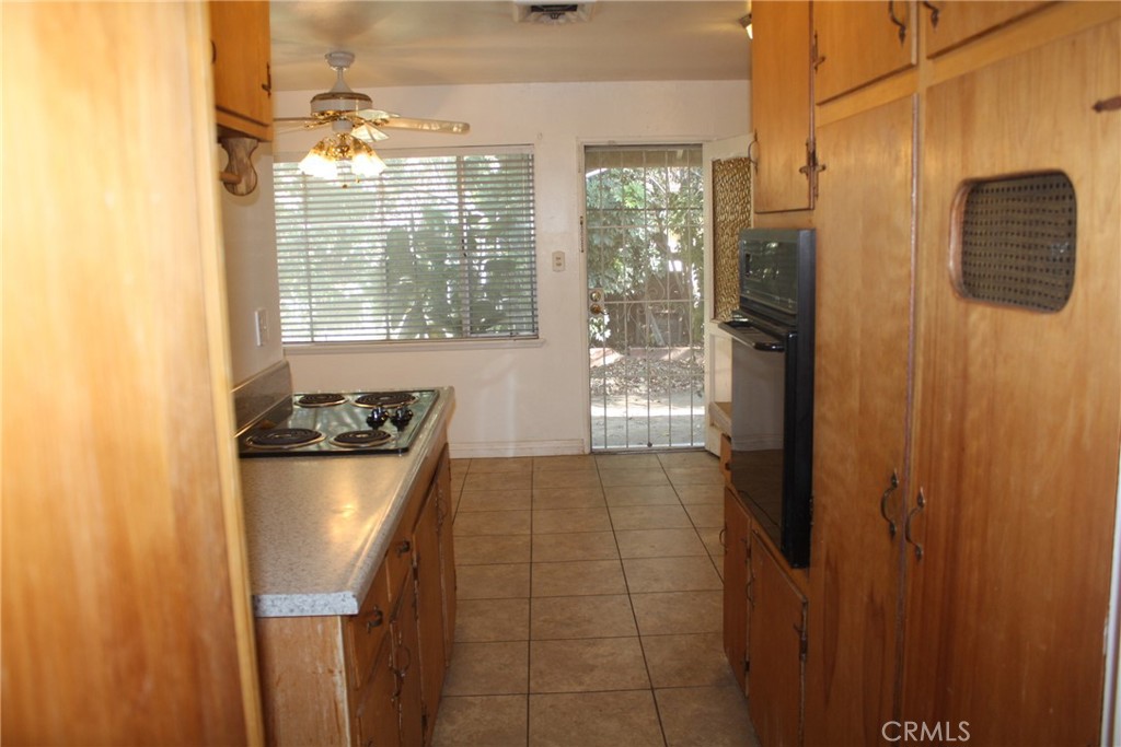6458 Rhonda Road Riverside, CA 92504 - Photo 16 of 47 a kitchen with stainless steel appliances a refrigerator and a window