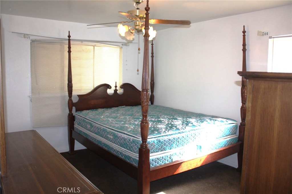 6458 Rhonda Road Riverside, CA 92504 - Photo 30 of 47 a bedroom with a bed and a chandelier