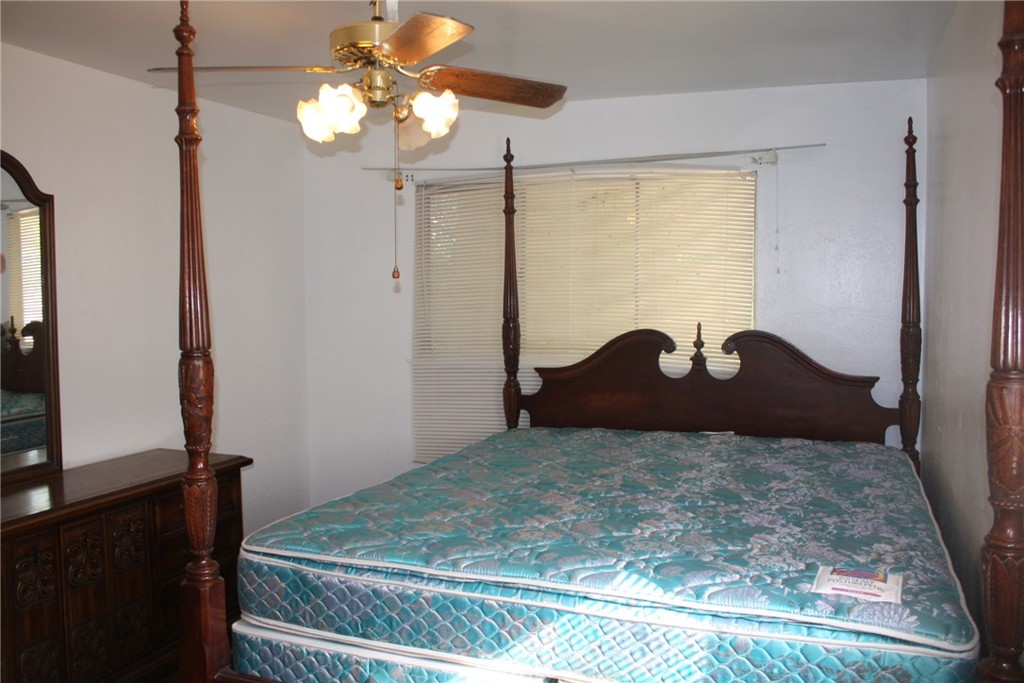 6458 Rhonda Road Riverside, CA 92504 - Photo 31 of 47 a bedroom with a bed and a chandelier