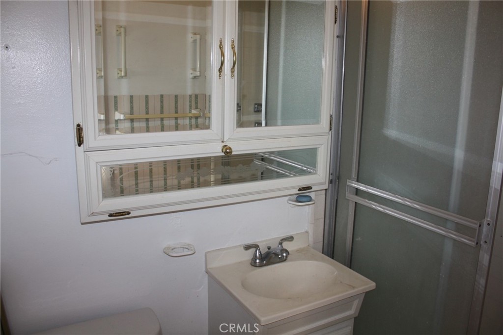 6458 Rhonda Road Riverside, CA 92504 - Photo 34 of 47 a bathroom with a sink and mirror with toilet