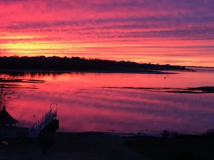 a sunset view with a lake