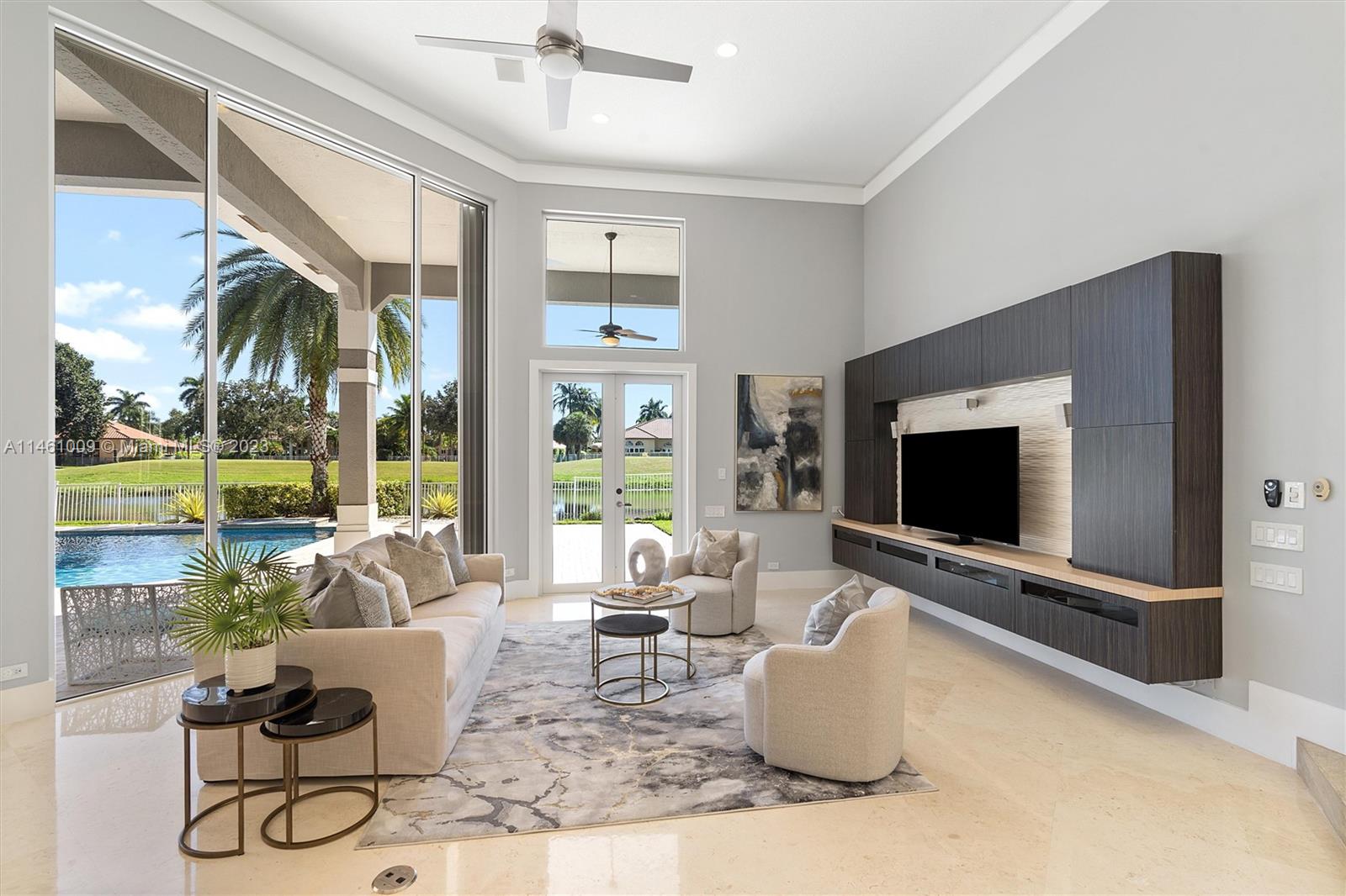 3088 Birkdale Drive Weston, FL 33332 - Photo 17 of 41 a living room with patio furniture and a flat screen tv