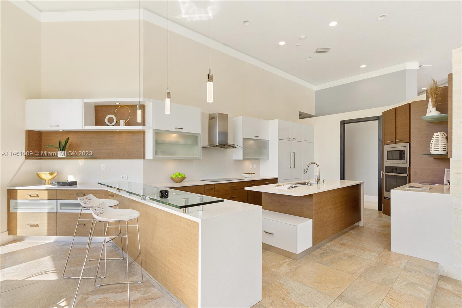 3088 Birkdale Drive Weston, FL 33332 - Photo 21 of 41 a kitchen that has a lot of cabinets in it and wooden floors