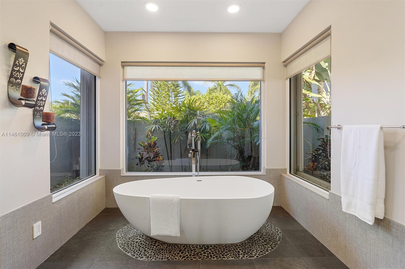 3088 Birkdale Drive Weston, FL 33332 - Photo 28 of 41 a white bath tub sitting in a bathroom next to a window