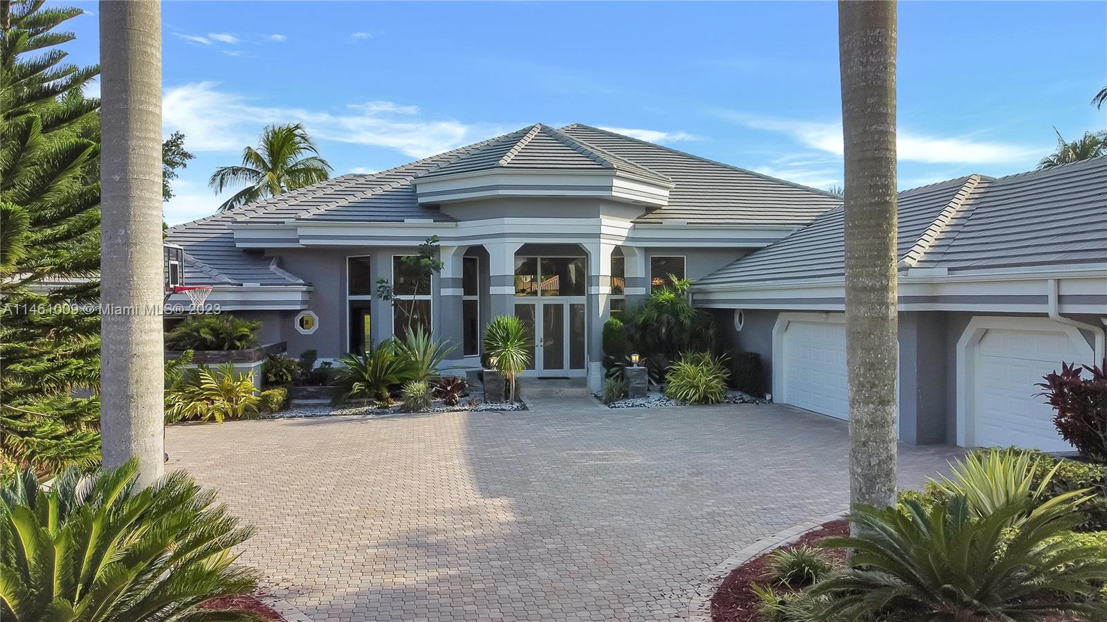 3088 Birkdale Drive Weston, FL 33332 - Photo 4 of 41 a front view of a house with garden