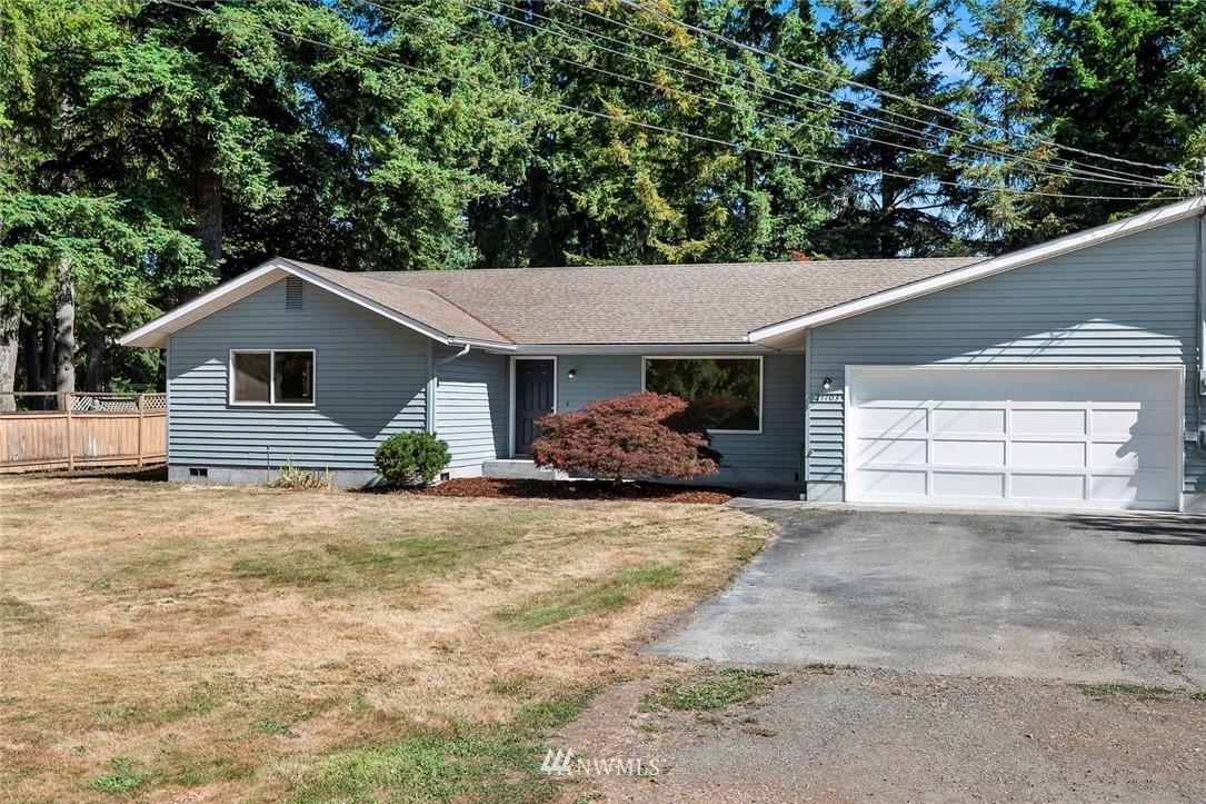 21705 Calhoun Road Monroe, WA 98272 - Photo 14 of 36 a front view of a house with a yard and garage
