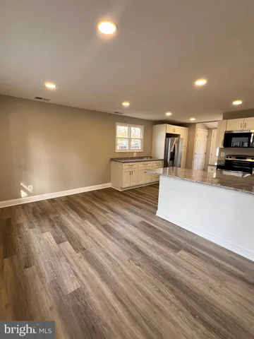 a view of kitchen with cabinets and wooden floor