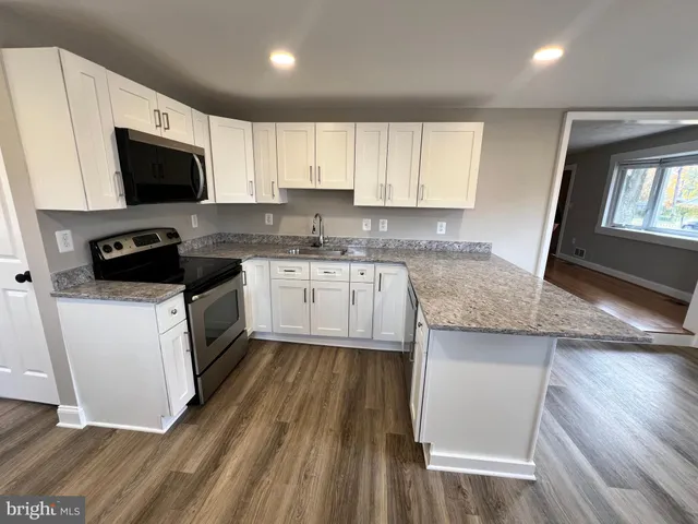 a kitchen with a sink stove and microwave