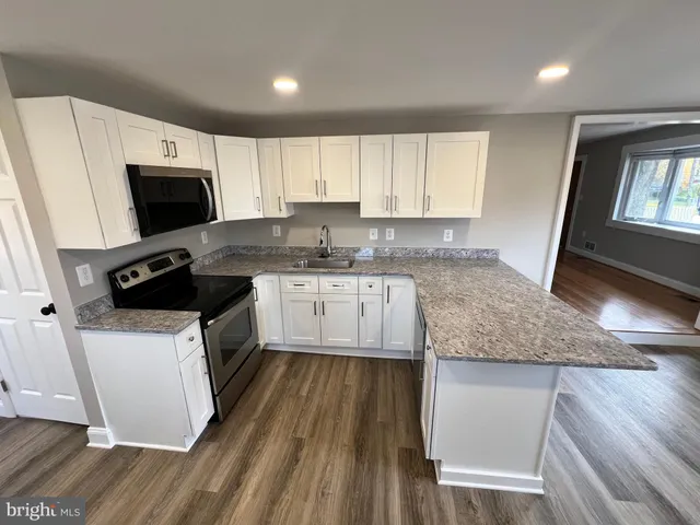 a kitchen with a sink a microwave a stove and refrigerator