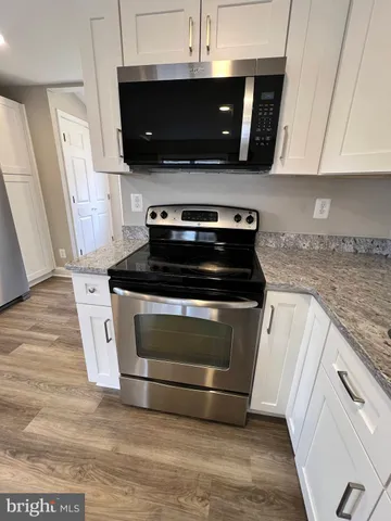a kitchen with a stove and a microwave