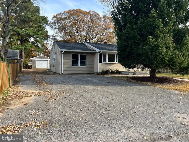 a house that has a tree in front of it