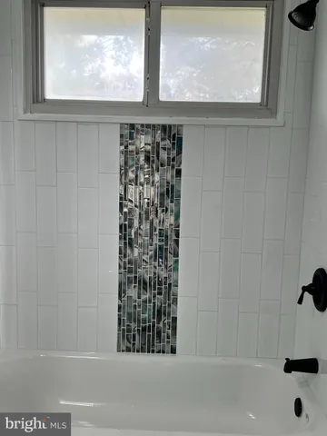 a bathroom with a bathtub and window