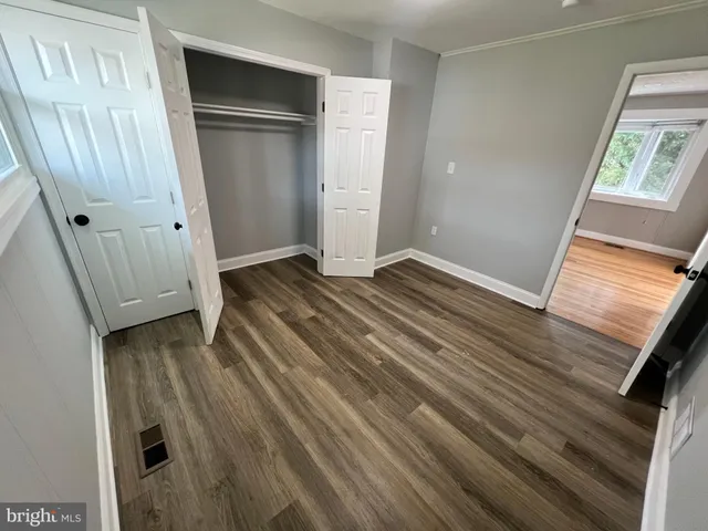 a view of a room with wooden floor and staircase