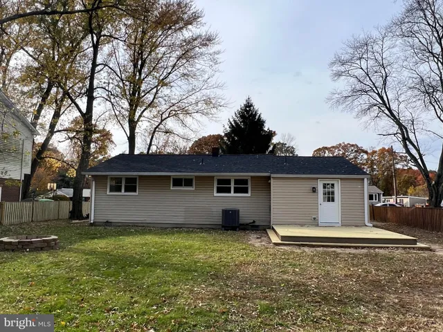 a front view of house with yard and trees
