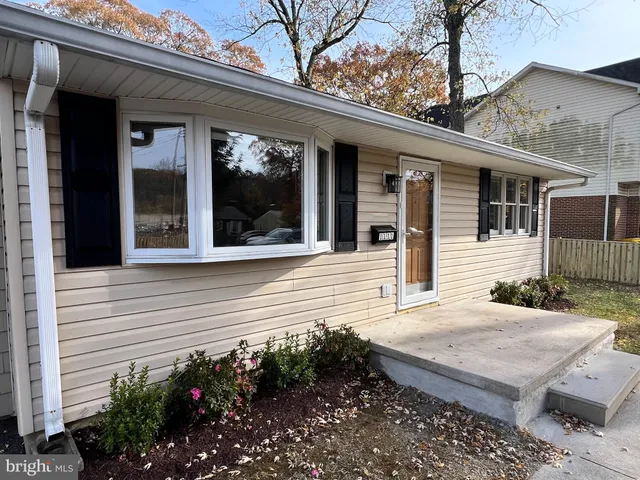 a view of a house with potted plants