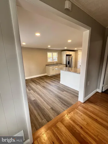 a view of a hallway to a house and wooden floor