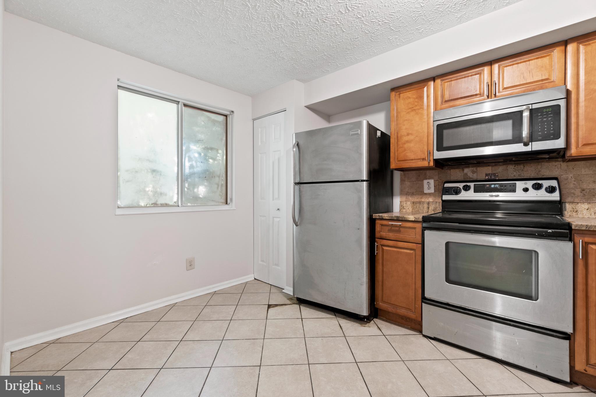 3618 Wharf Lane Triangle, VA 22172 - Photo 12 of 27 a view of a kitchen with a stove cabinets and a refrigerator