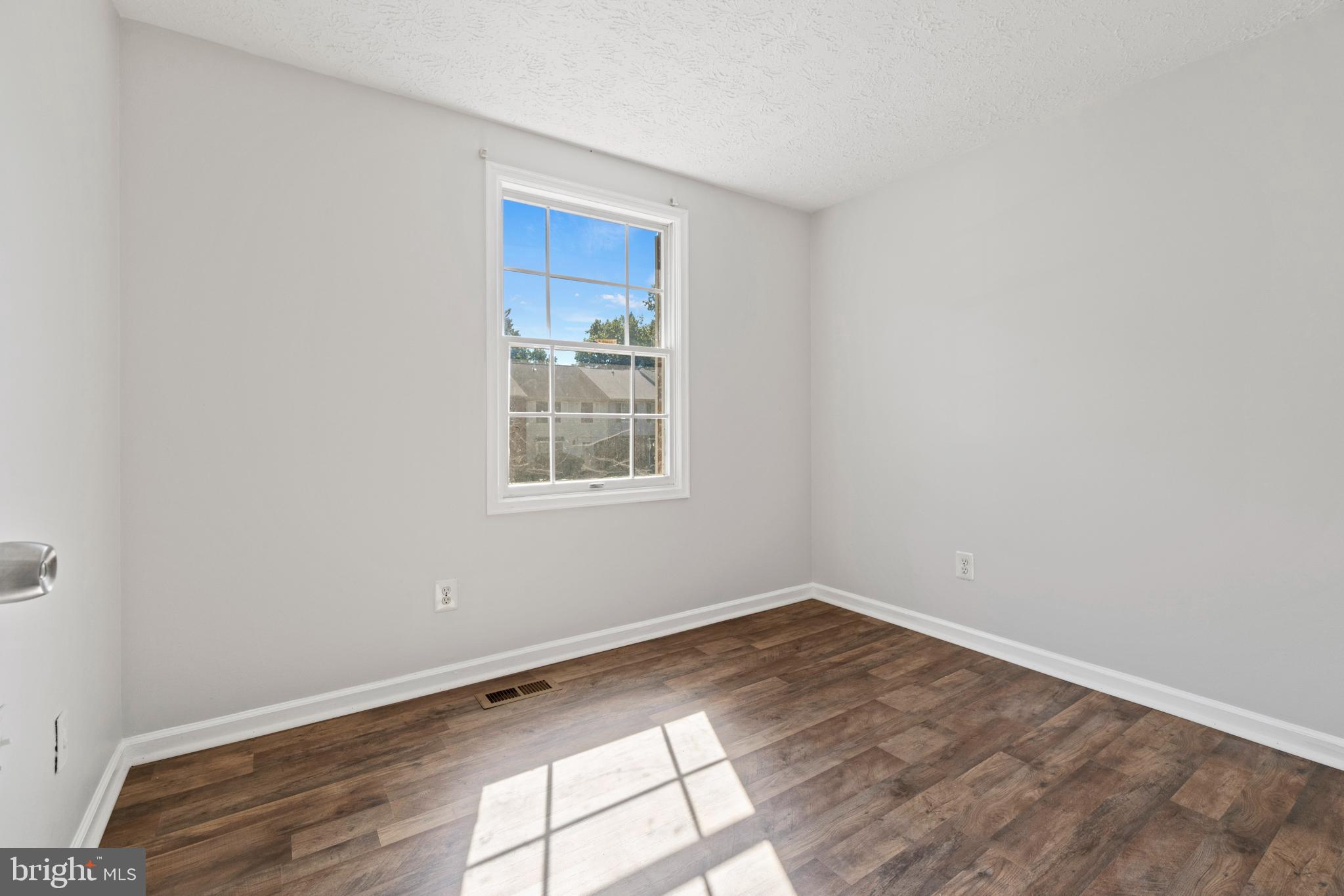 3618 Wharf Lane Triangle, VA 22172 - Photo 14 of 27 an empty room with wooden floor and windows
