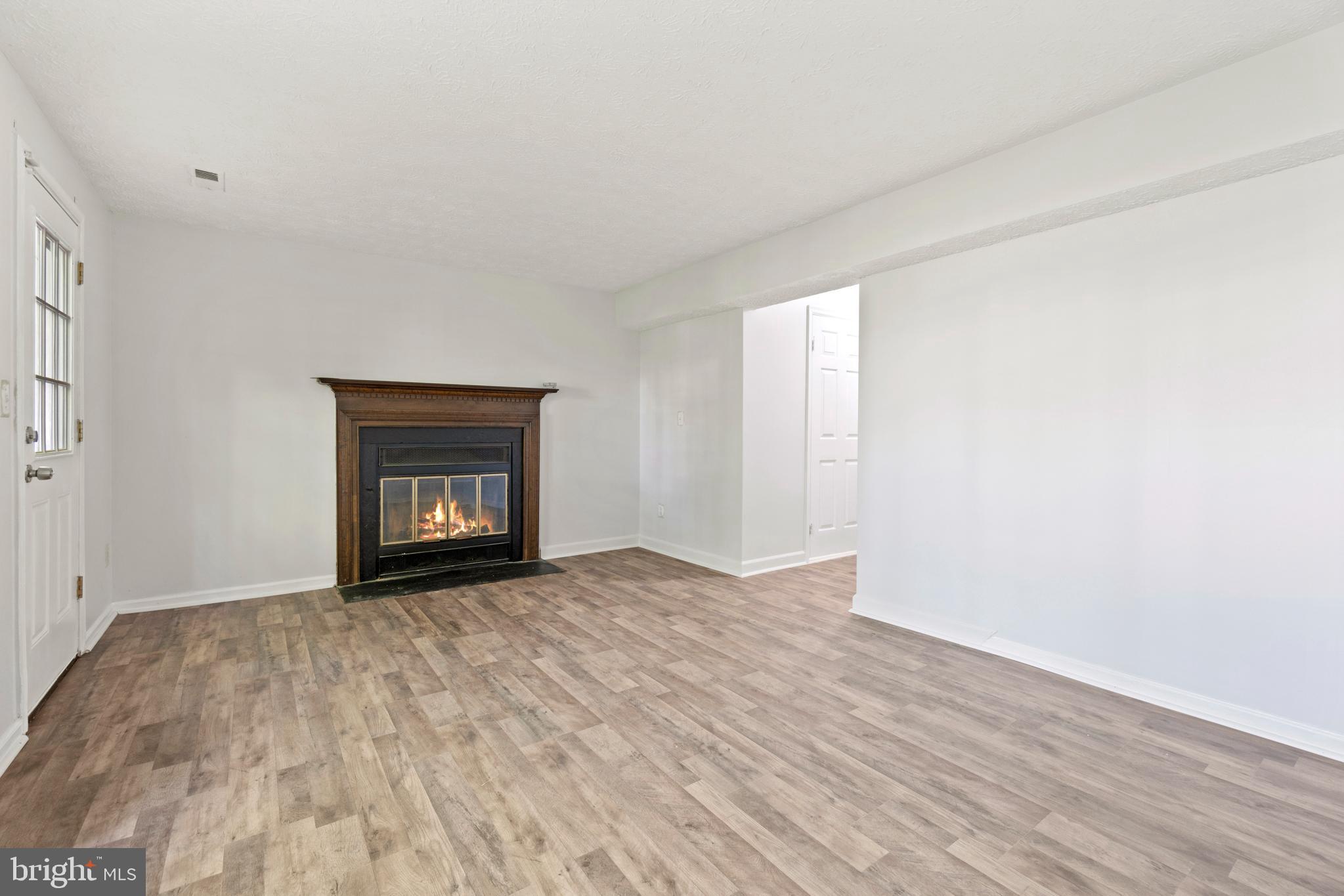 3618 Wharf Lane Triangle, VA 22172 - Photo 18 of 27 a view of an empty room with a fireplace and a window