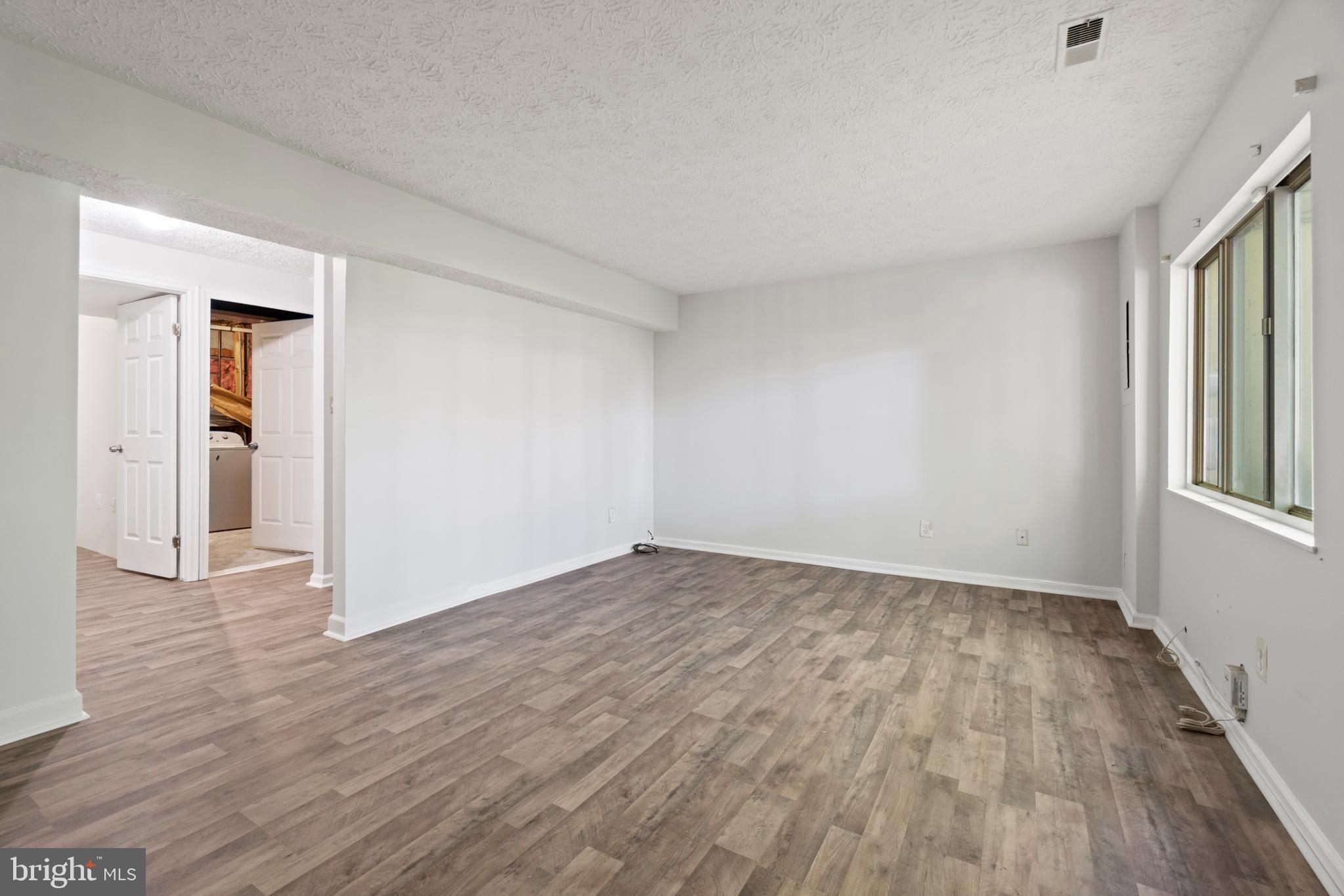 3618 Wharf Lane Triangle, VA 22172 - Photo 19 of 27 wooden floor in an empty room with a window