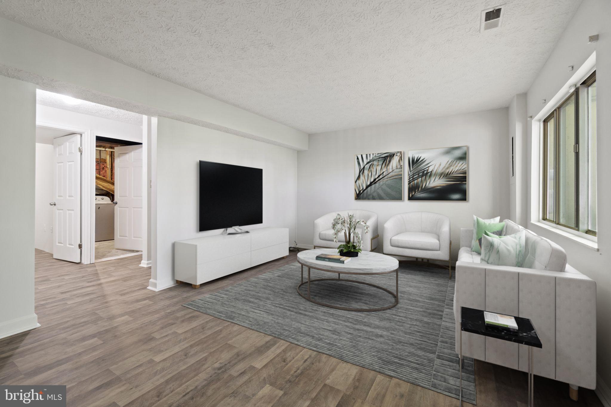 3618 Wharf Lane Triangle, VA 22172 - Photo 4 of 27 a living room with couches and a flat screen tv