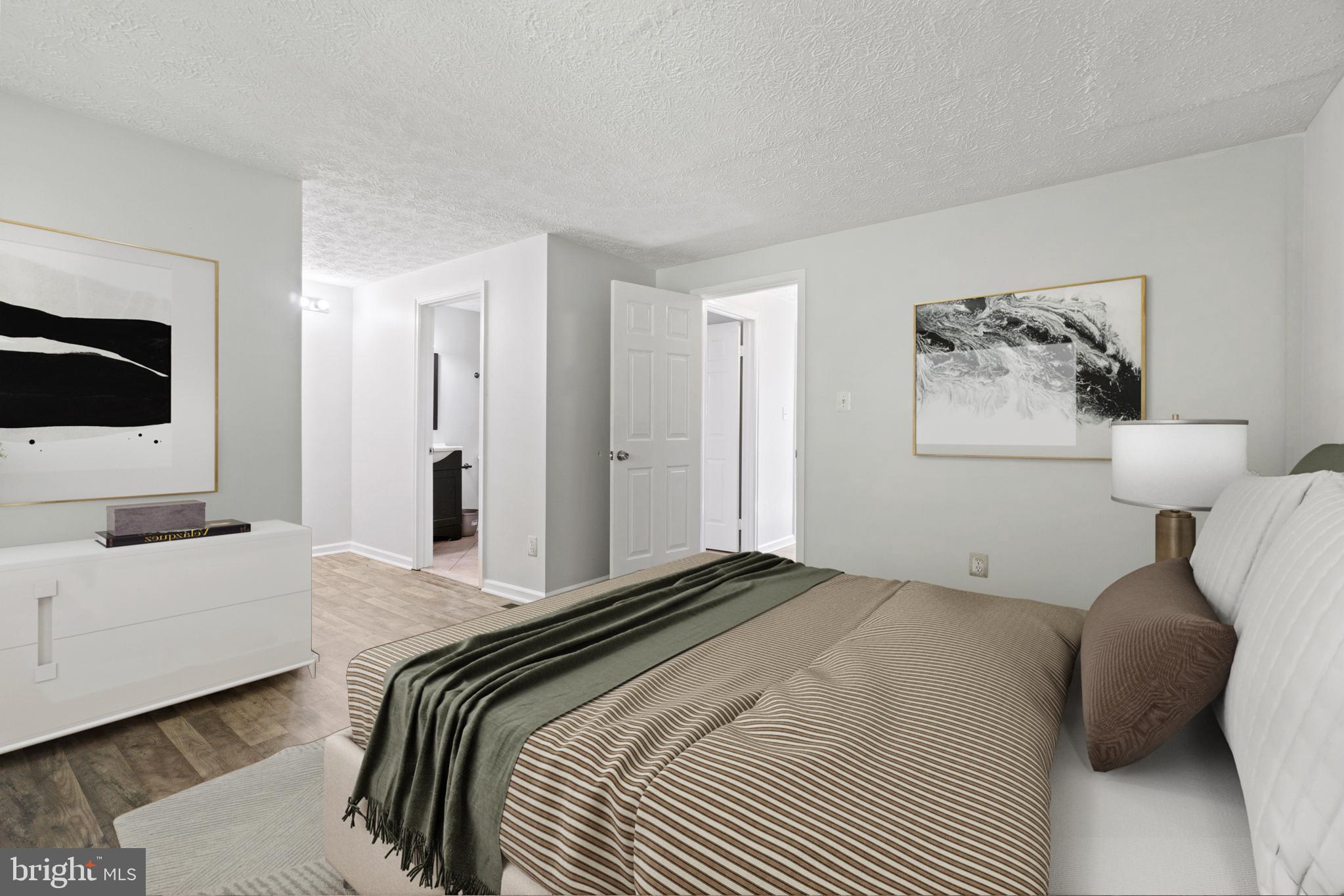 3618 Wharf Lane Triangle, VA 22172 - Photo 6 of 27 a bedroom with a bed and a flat screen tv