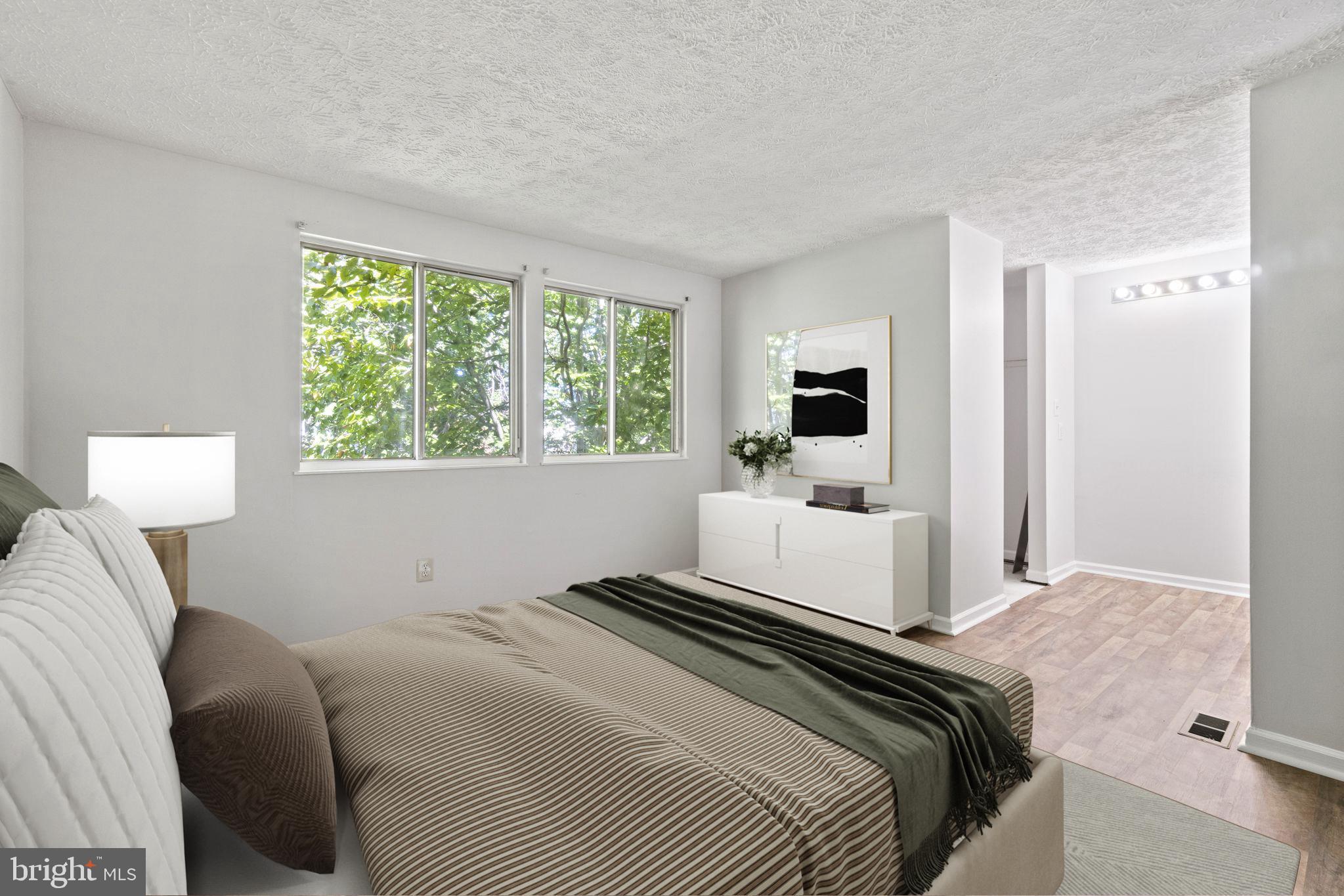 3618 Wharf Lane Triangle, VA 22172 - Photo 8 of 27 a bedroom with a large bed and a tv