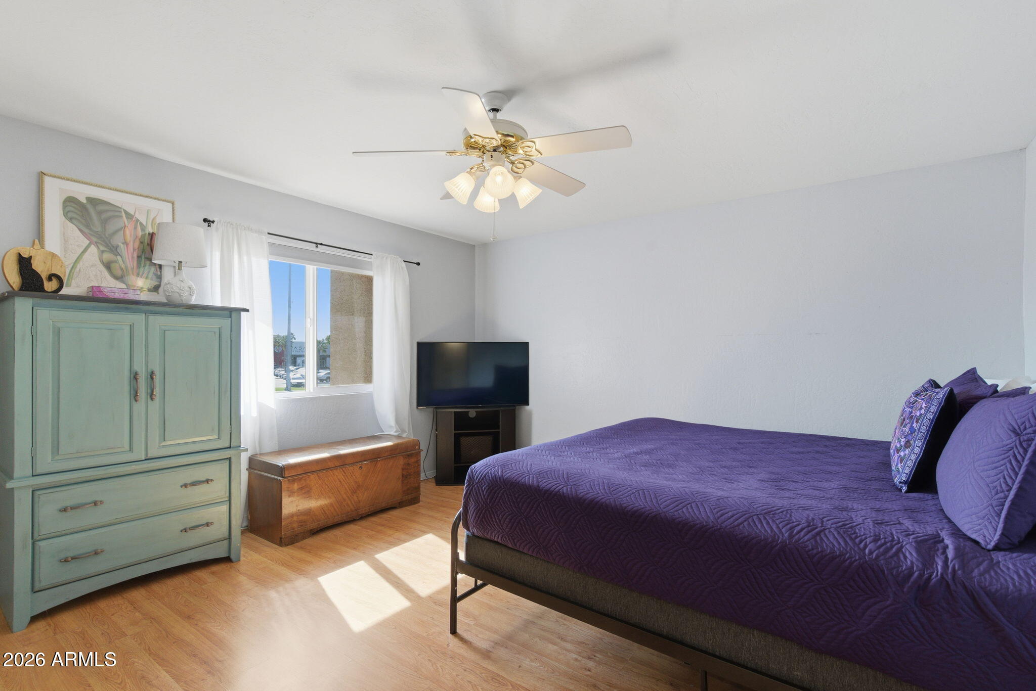 4218 West Boca Raton Road Phoenix, AZ 85053 - Photo 10 of 27 a bedroom with a bed and a chandelier