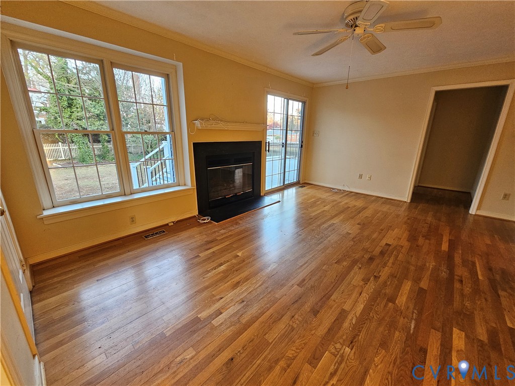 8002 Galaxie Circle Henrico, VA 23228 - Photo 9 of 49 a view of an empty room with a window and wooden floor
