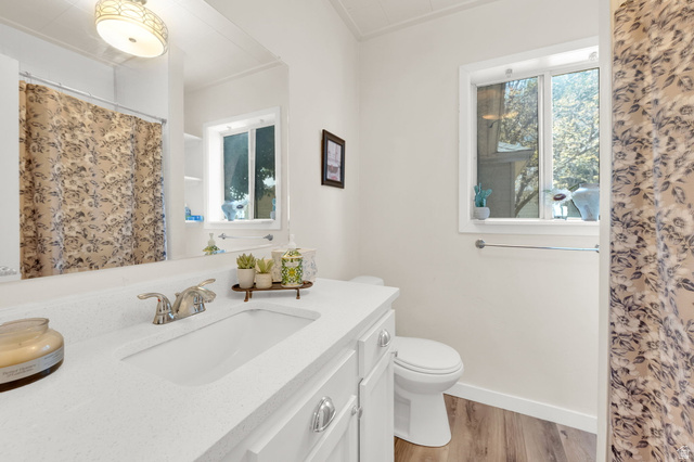 501 Canyon Road Ogden, UT 84404 - Photo 20 of 30 Bathroom featuring a white vanity with an integrated sink, chrome faucet, and spacious mirror