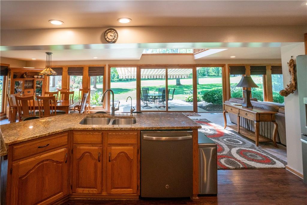 680 Neville Road Beaver, PA 15009 - Photo 5 of 25 Kitchen looking over Granite Counter, Dining Room and Outside Patio
