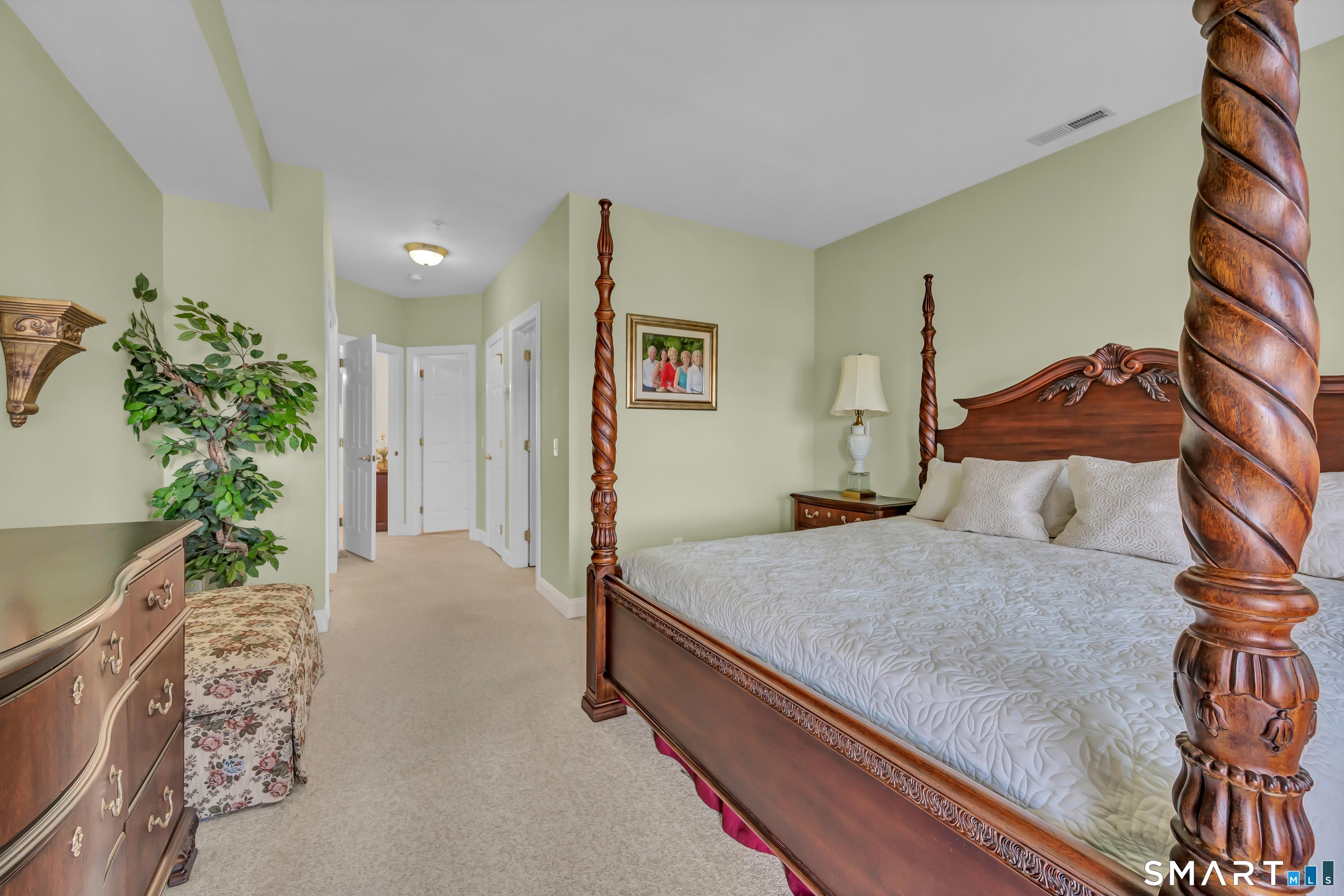 10 Hayestown Road, Unit 321 Danbury, CT 06811 - Photo 19 of 39 a spacious bedroom with a large bed and a potted plant