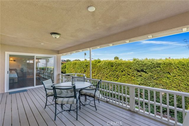 a view of a chairs and table on the wooden deck