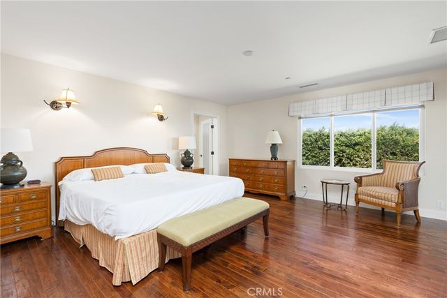 a bedroom with a bed a table and chair