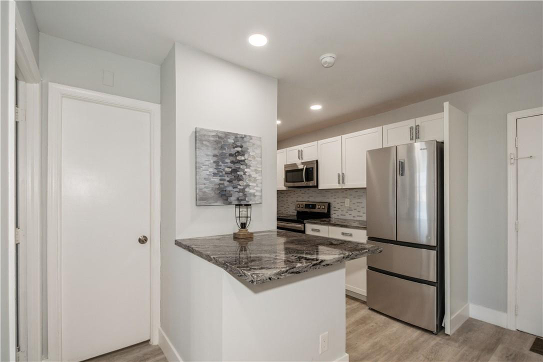 200 South Birch Road, Unit 612 Fort Lauderdale, FL 33316 - Photo 16 of 32 a kitchen with stainless steel appliances granite countertop a refrigerator and a stove top oven