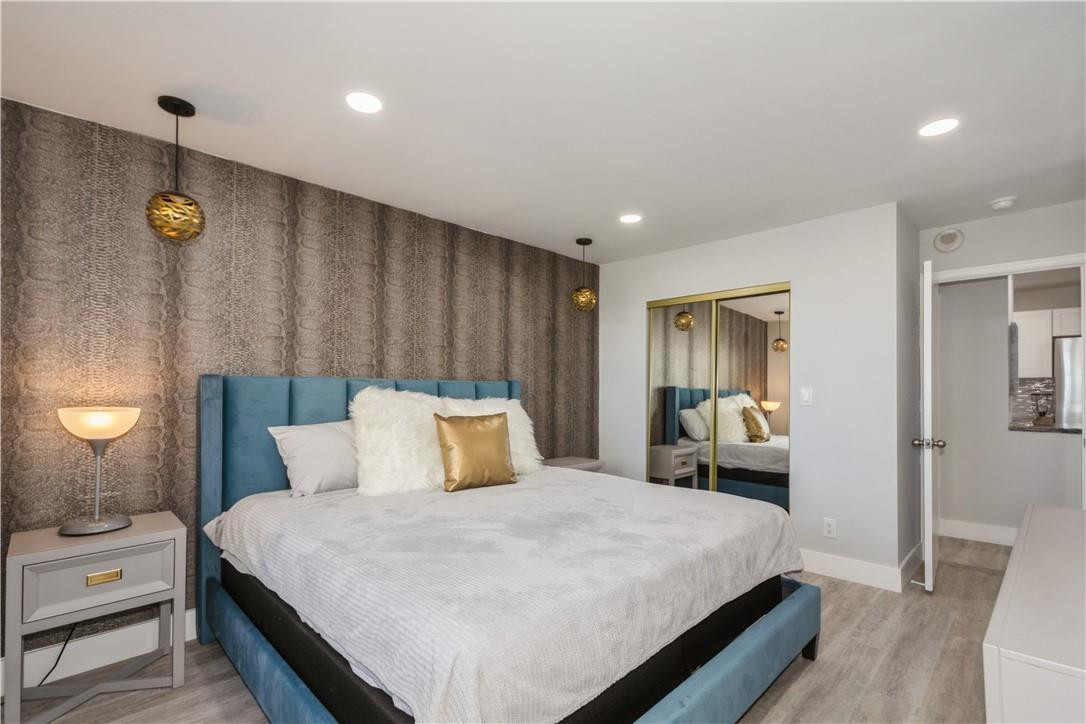 200 South Birch Road, Unit 612 Fort Lauderdale, FL 33316 - Photo 22 of 32 a bedroom with a bed and a lamp