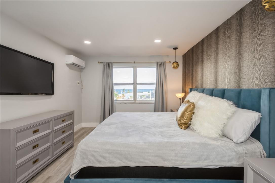 200 South Birch Road, Unit 612 Fort Lauderdale, FL 33316 - Photo 24 of 32 a bedroom with a large bed and a flat screen tv