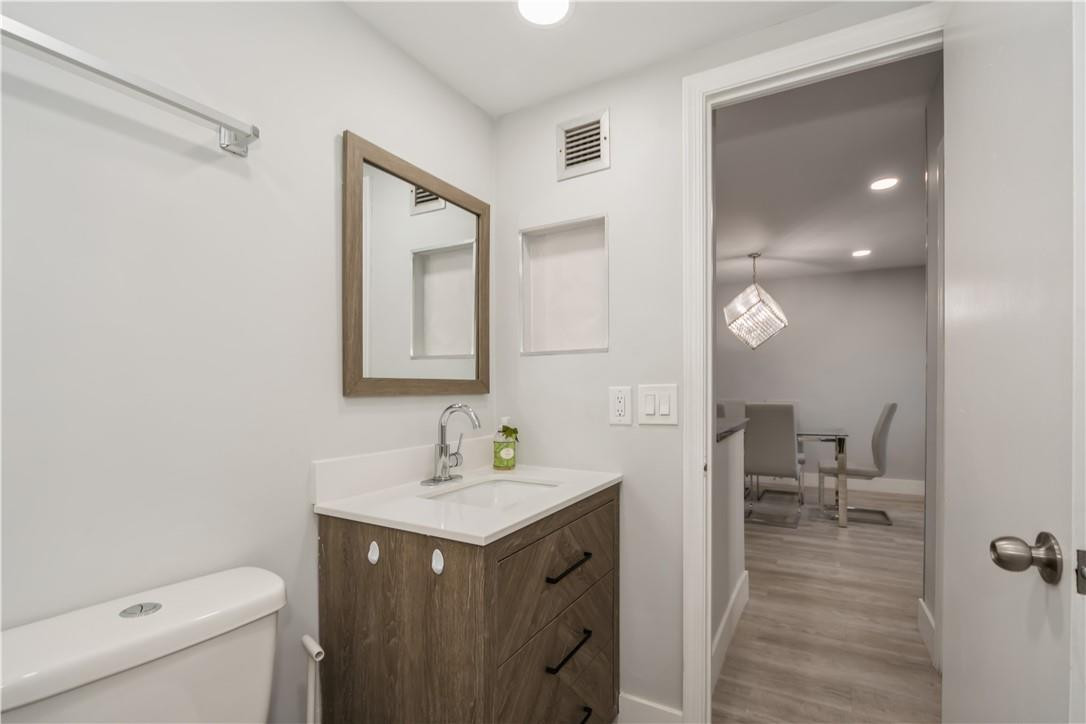 200 South Birch Road, Unit 612 Fort Lauderdale, FL 33316 - Photo 26 of 32 a en suite bathroom with a sink a toilet and a mirror