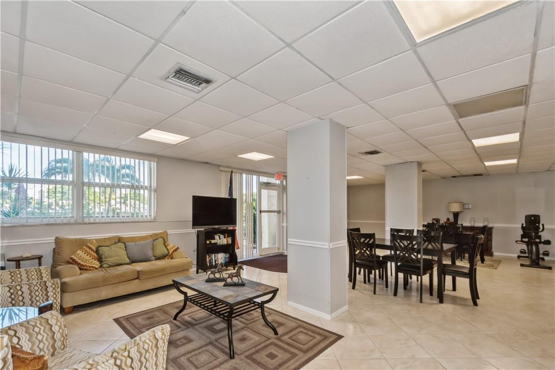 200 South Birch Road, Unit 612 Fort Lauderdale, FL 33316 - Photo 32 of 32 a living room with furniture and a flat screen tv