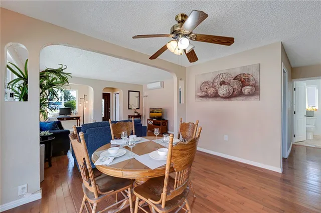 a view of a dining room with furniture and wooden floor