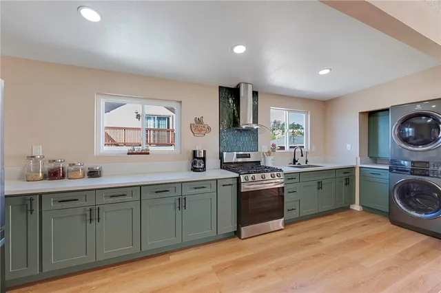 a kitchen with a sink a stove and cabinets