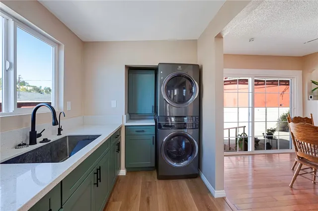 a kitchen with wooden cabinets a sink a stove and wooden floor
