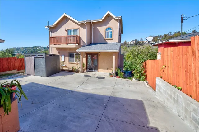 a view of a house with wooden fence
