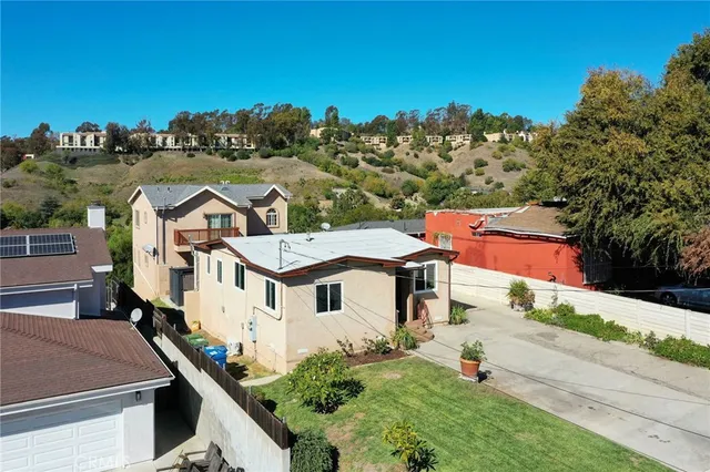 an aerial view of a house with a yard and pool