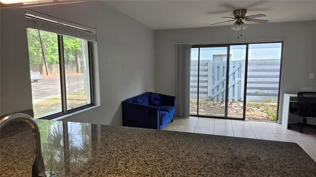 a living room filled with furniture and a floor to ceiling window