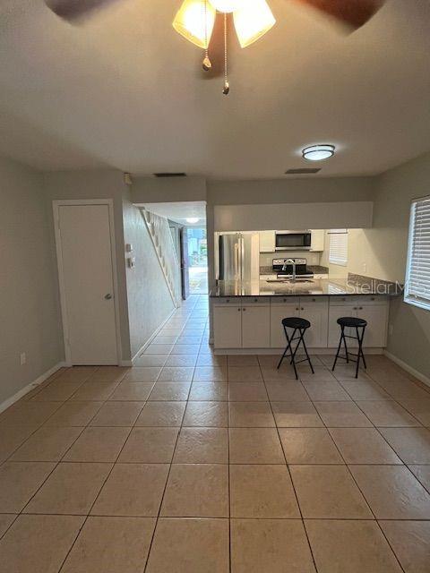 3600 Southwest 19th Avenue, Unit 41D Gainesville, FL 32607 - Photo 4 of 23 a kitchen with stainless steel appliances a sink a counter top space cabinets and counter space