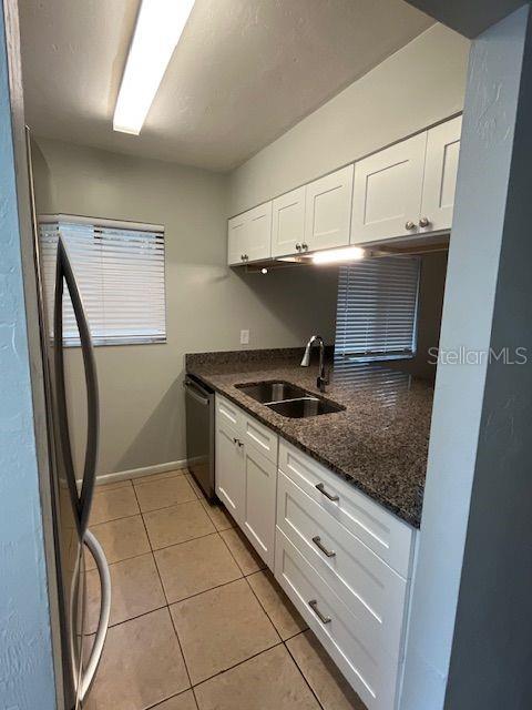 3600 Southwest 19th Avenue, Unit 41D Gainesville, FL 32607 - Photo 6 of 23 a kitchen with stainless steel appliances granite countertop a sink stove and cabinets