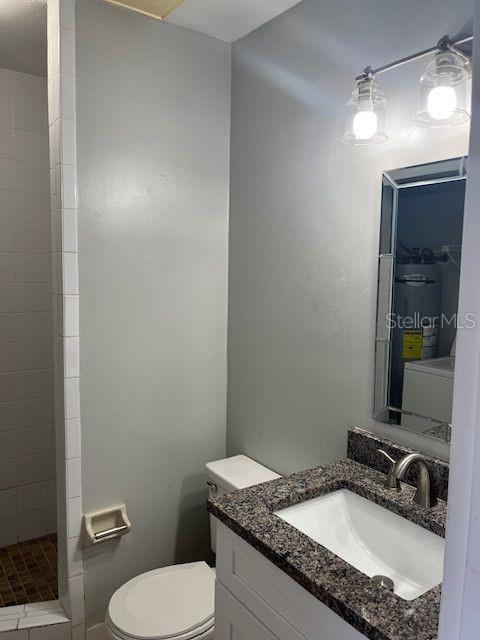 3600 Southwest 19th Avenue, Unit 41D Gainesville, FL 32607 - Photo 10 of 23 a bathroom with a granite countertop sink and a mirror